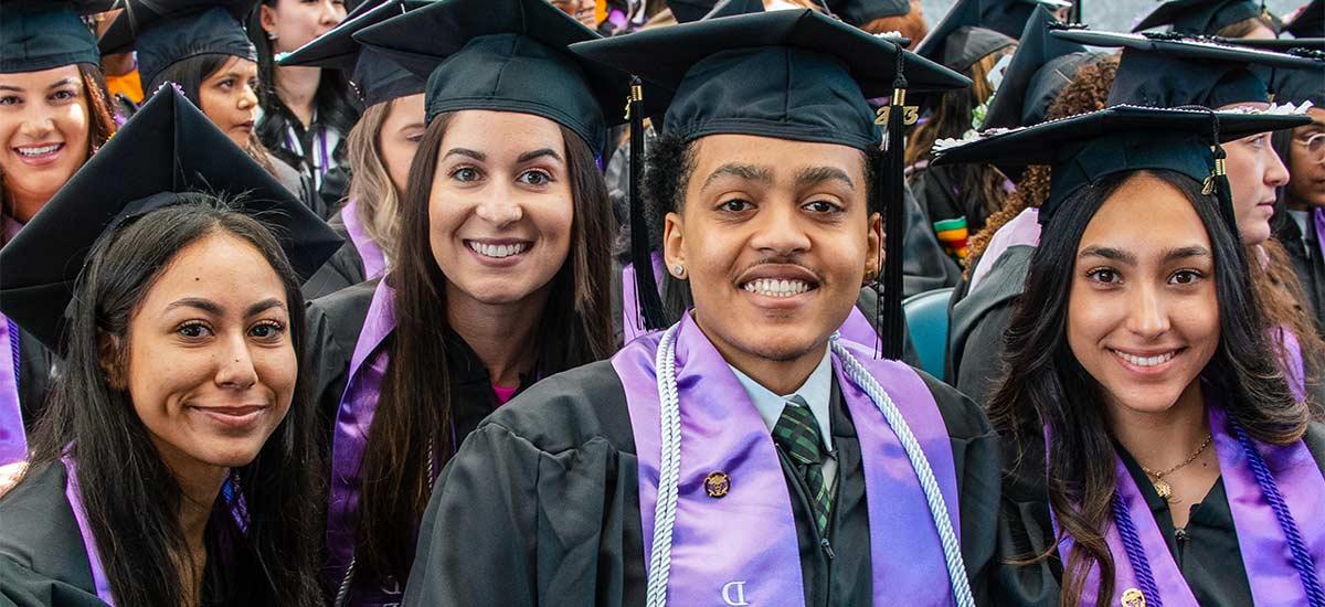 University of Bridgeport graduate in front of the water