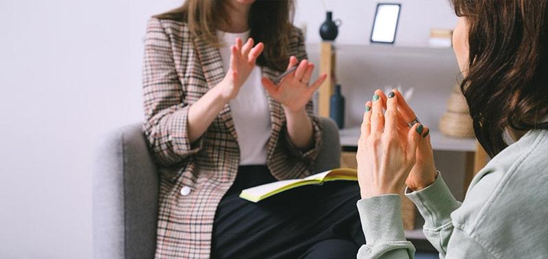 two people talking with a focus on their hands